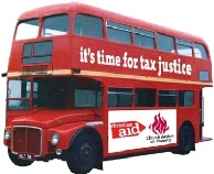 Red double decker bus with Tax Justice slogan