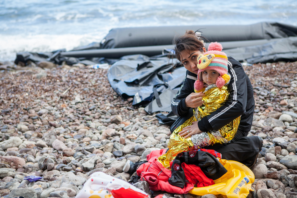 rescued child on wrapped up, beach